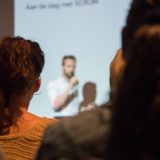 Audience view of someone speaking during a presentation